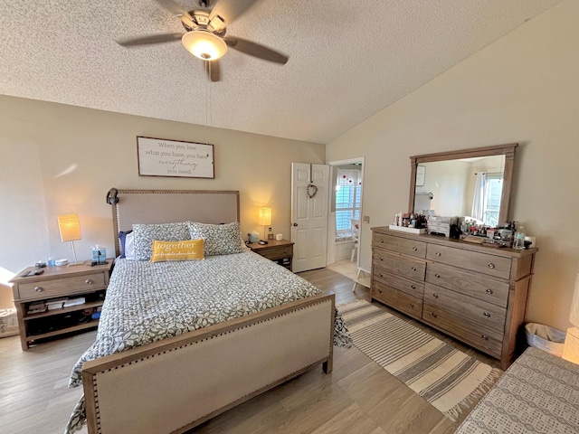 2733 SE Garfield Ave, Port Saint Lucie, FL 34952 - bedroom featuring vaulted ceiling, a textured ceiling, a ceiling fan, and light wood-style flooring