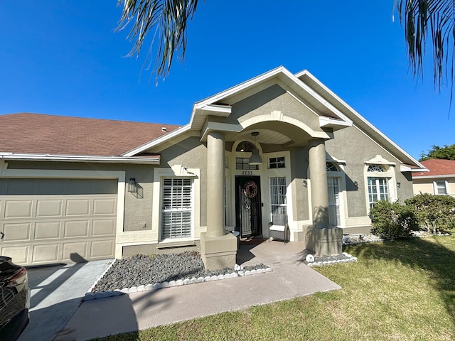 view of front of property featuring a garage and a front lawn