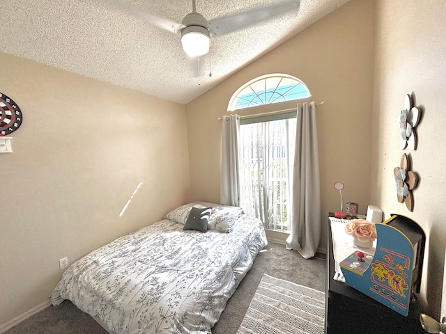 bedroom with lofted ceiling, dark carpet, a textured ceiling, and ceiling fan