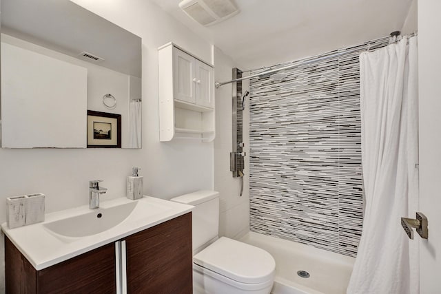 bathroom featuring curtained shower, vanity, and toilet