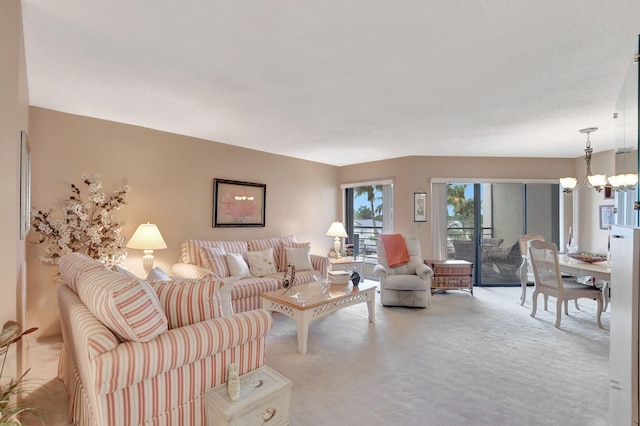 living room featuring carpet floors and a notable chandelier