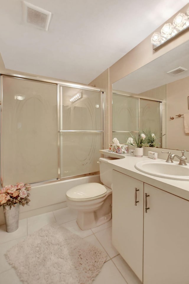 full bathroom with vanity, tile patterned floors, enclosed tub / shower combo, and toilet