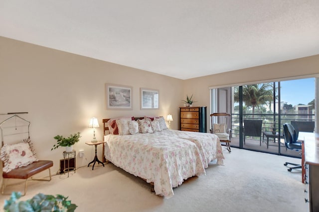 bedroom with access to outside and light colored carpet