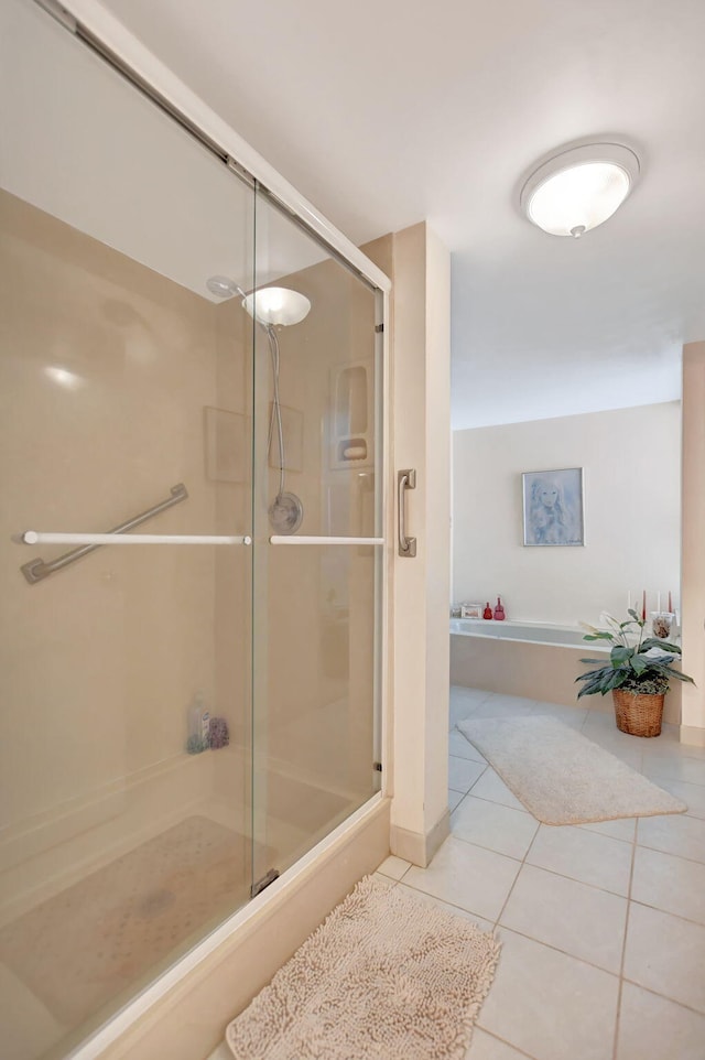 bathroom with tile patterned floors and a shower with door