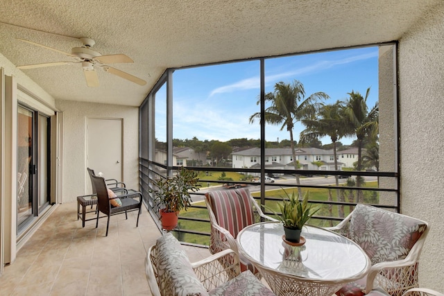 sunroom / solarium with a ceiling fan