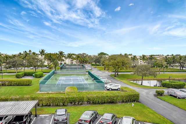 surrounding community featuring a lawn and a water view