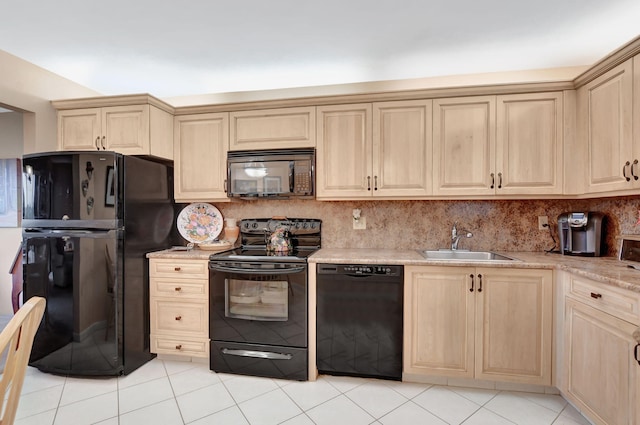 kitchen with decorative backsplash, light brown cabinets, a sink, and black appliances