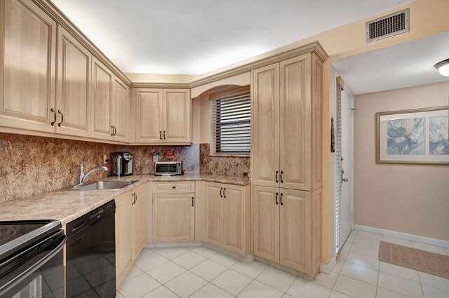 kitchen with backsplash, light tile patterned floors, sink, and black appliances