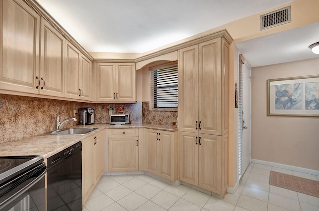 kitchen with sink, light tile patterned floors, black dishwasher, light stone counters, and light brown cabinets