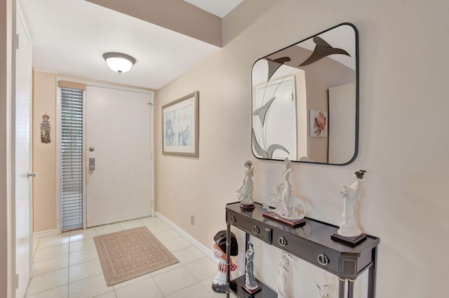 tiled entryway featuring baseboards