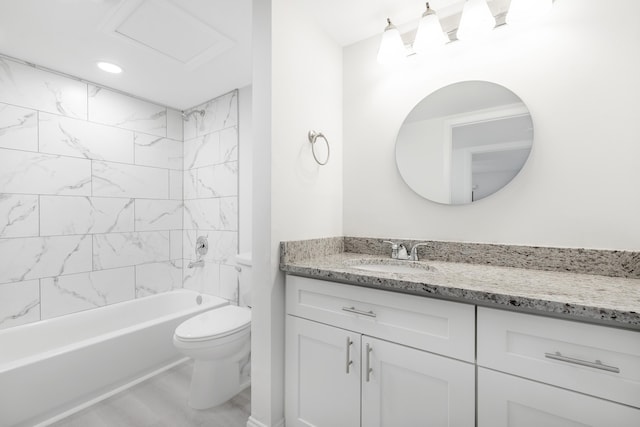 full bathroom featuring toilet, vanity, and tiled shower / bath