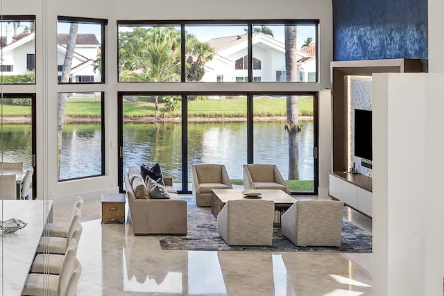 living room with plenty of natural light and a water view