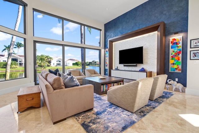 living room featuring a towering ceiling and a wealth of natural light