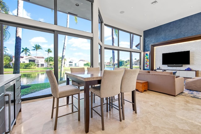 dining room featuring a water view and plenty of natural light