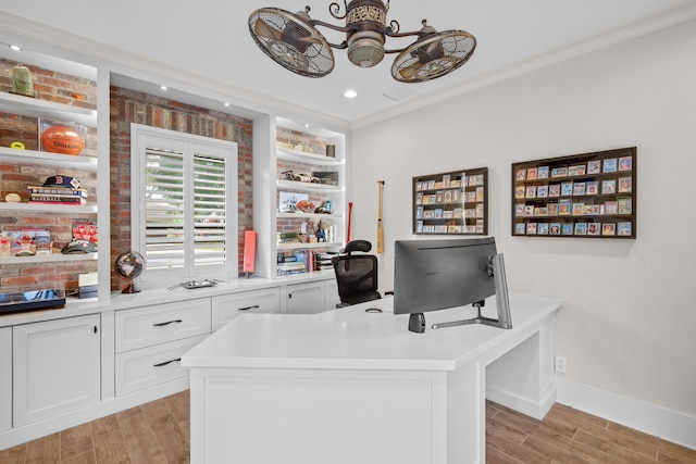 office space featuring brick wall, ceiling fan, and crown molding