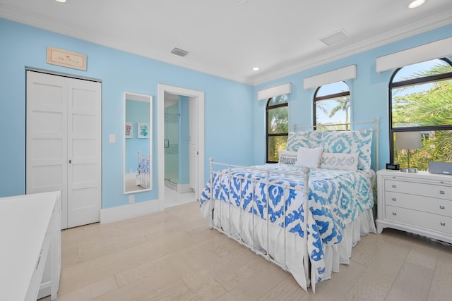 bedroom featuring light wood-type flooring, a closet, and crown molding