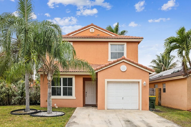 mediterranean / spanish-style home with a front yard and a garage