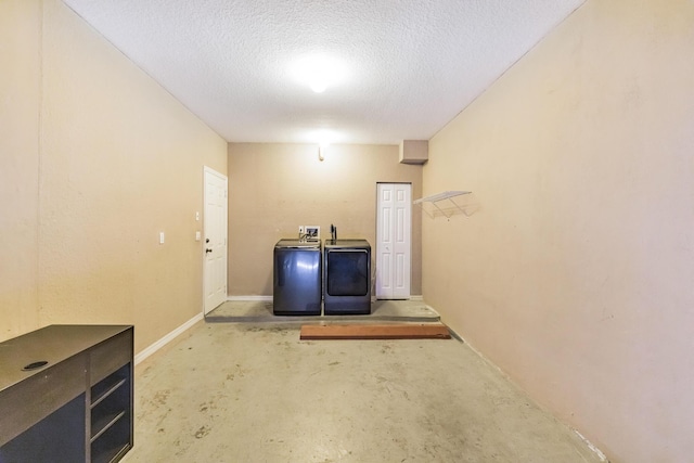 basement featuring a textured ceiling and washing machine and dryer