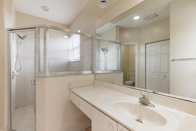 bathroom with toilet, walk in shower, and vanity