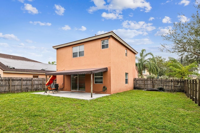 rear view of property with a patio and a yard