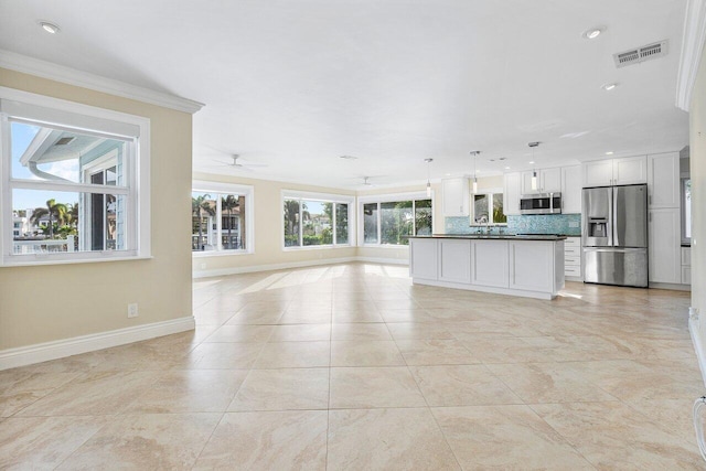 unfurnished living room with ceiling fan, light tile patterned flooring, and crown molding