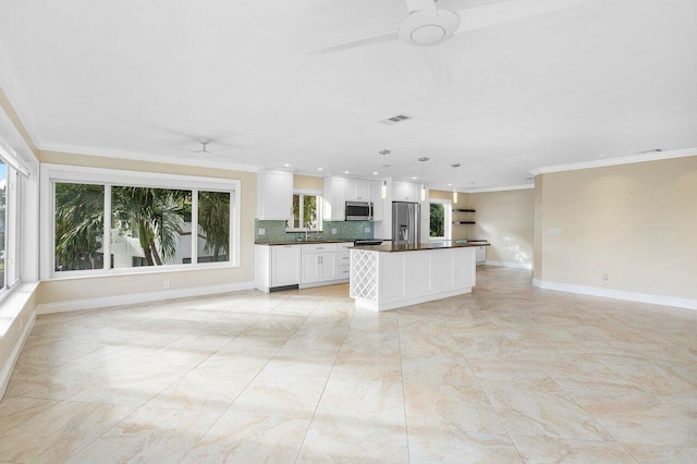 kitchen with ceiling fan, a center island, white cabinetry, hanging light fixtures, and stainless steel appliances