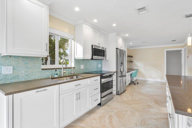 kitchen featuring white cabinetry, stainless steel appliances, hanging light fixtures, crown molding, and sink