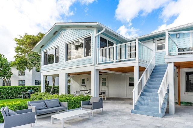 back of house featuring a patio area and outdoor lounge area