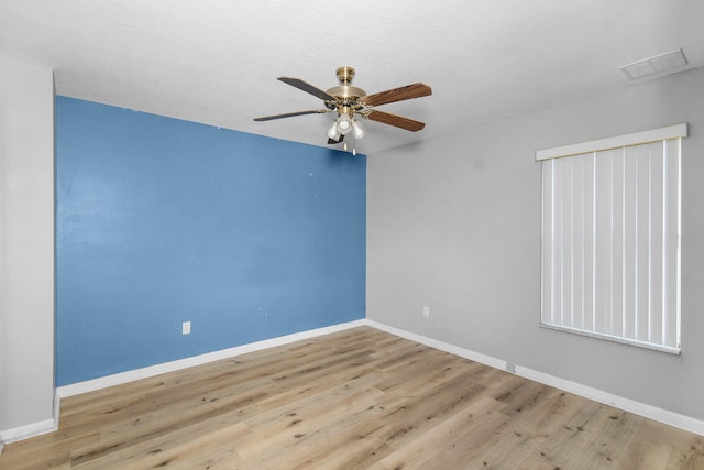 empty room featuring ceiling fan and light hardwood / wood-style floors