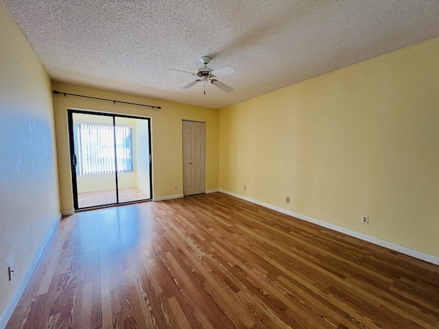 unfurnished room featuring a textured ceiling, ceiling fan, and light hardwood / wood-style flooring