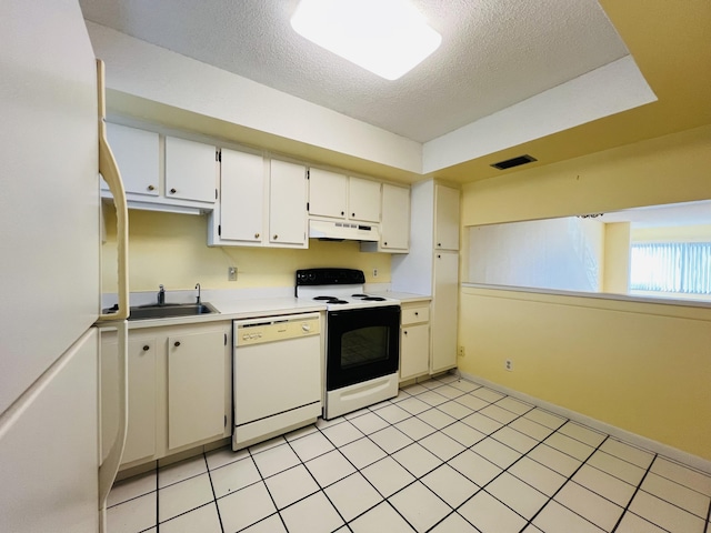 kitchen featuring light tile patterned flooring, sink, white appliances, white cabinetry, and a textured ceiling