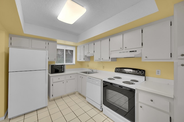 kitchen with a textured ceiling, a sink, light countertops, under cabinet range hood, and white appliances