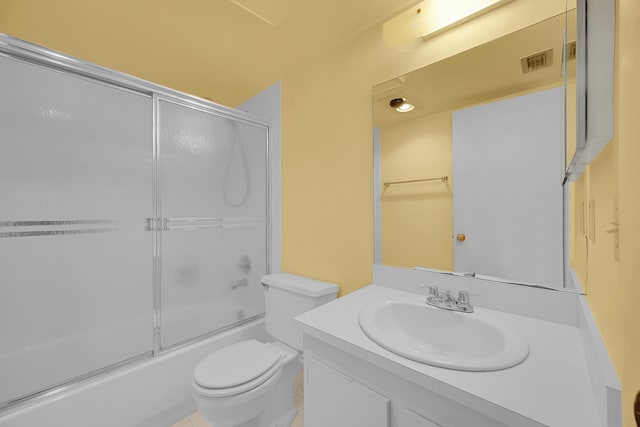 bathroom featuring visible vents, bath / shower combo with glass door, toilet, and vanity