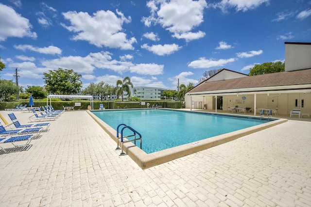 pool featuring a patio and fence