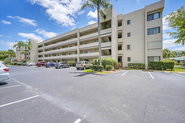 view of property featuring uncovered parking