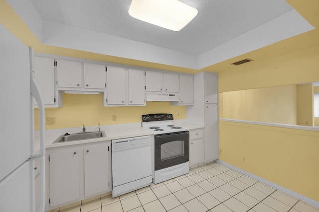 kitchen with visible vents, a sink, light countertops, under cabinet range hood, and white appliances