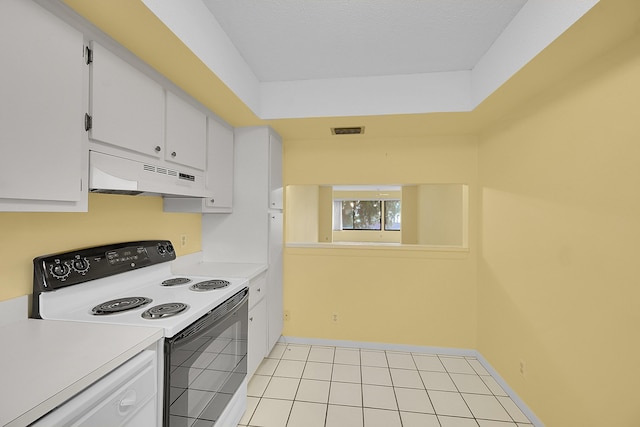 kitchen featuring visible vents, electric range, under cabinet range hood, and white cabinetry
