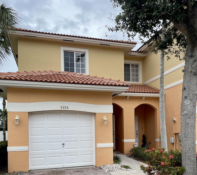 mediterranean / spanish-style home featuring a garage