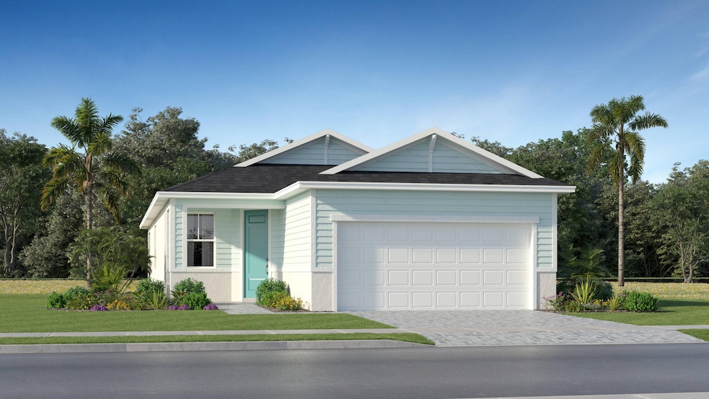 view of front of house featuring a front lawn and a garage