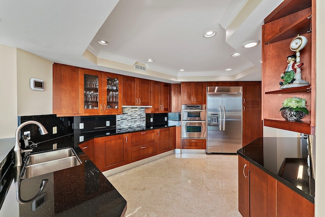 kitchen featuring sink, ornamental molding, appliances with stainless steel finishes, a raised ceiling, and decorative backsplash