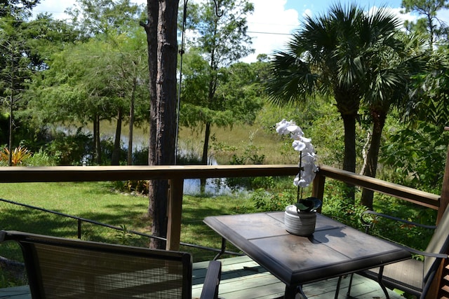 balcony featuring a deck with water view