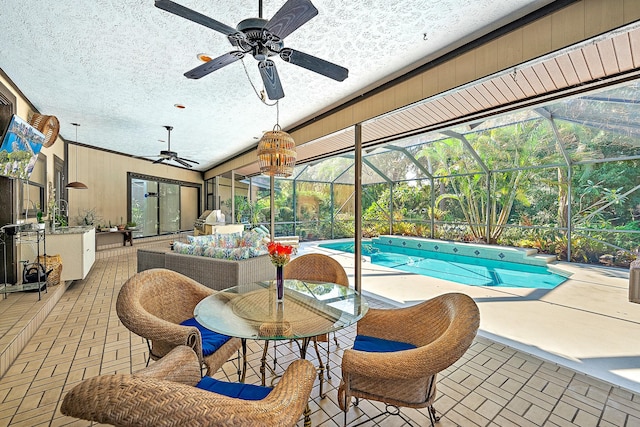 view of swimming pool with ceiling fan, a lanai, an outdoor hangout area, and a patio area