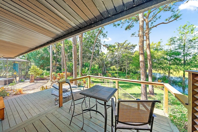 wooden terrace featuring a water view