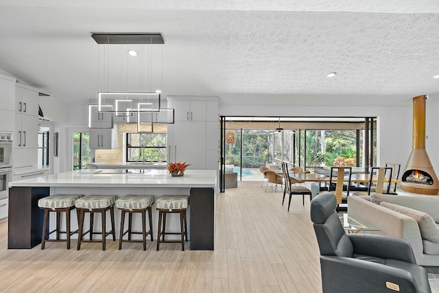 kitchen with a spacious island, a kitchen bar, and hanging light fixtures