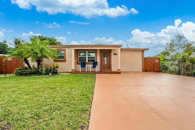 ranch-style home with a porch and a front lawn