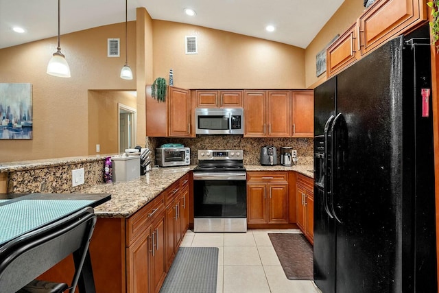 kitchen with appliances with stainless steel finishes, kitchen peninsula, light tile patterned floors, pendant lighting, and tasteful backsplash