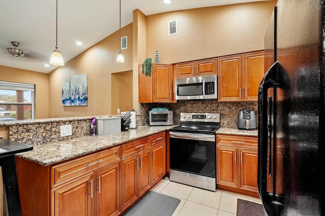 kitchen with decorative light fixtures, light stone counters, lofted ceiling, kitchen peninsula, and appliances with stainless steel finishes