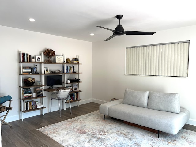 living area with ceiling fan and dark hardwood / wood-style flooring