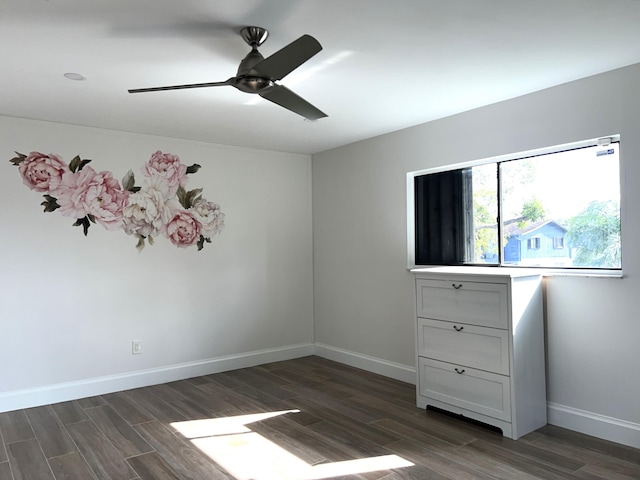 unfurnished bedroom featuring ceiling fan and dark hardwood / wood-style floors