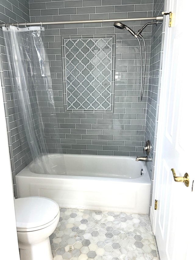 bathroom with toilet and shower / bath combo with shower curtain